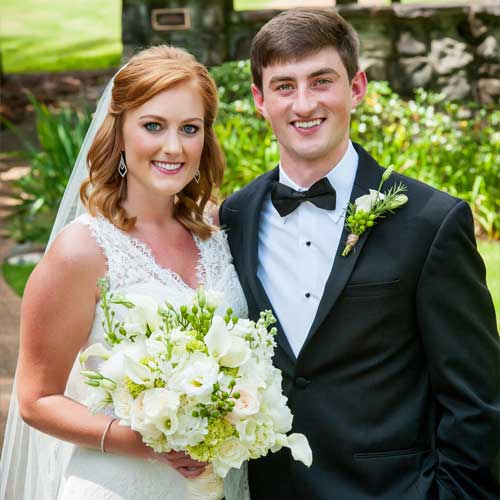 Bride and Groom posing for the camera on their wedding day