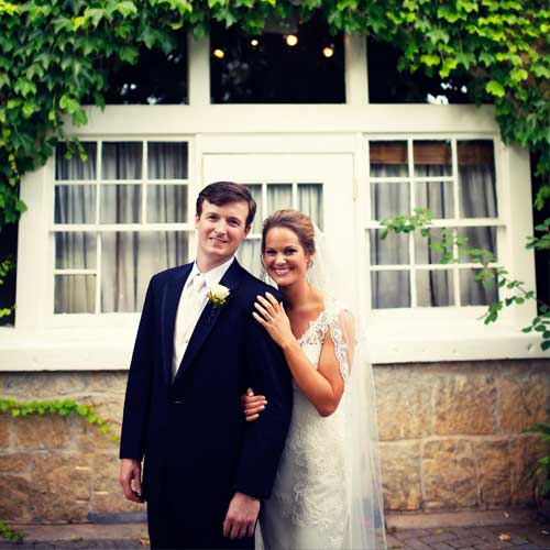 Bride holding Groom after wedding reception